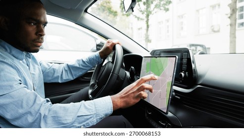 Man Navigating With GPS Map On Car Dashboard As Auto Navigator. Young African Male Tracking Speedometer Using GPS Map