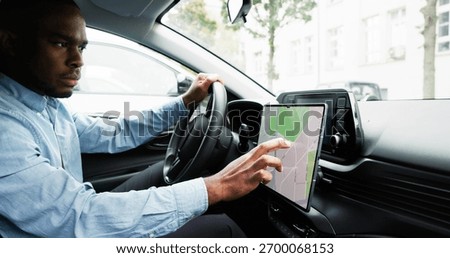 Man Navigating With GPS Map On Car Dashboard As Auto Navigator. Young African Male Tracking Speedometer Using GPS Map