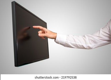 Man Navigating A Modern Wall Mounted High Definition Touch Screen Computer Monitor With His Finger , Close Up View Of His Arm And Angled Screen.