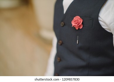 Man In Navyblue Vest Suit With  Flower Brooch Pin, And Pink Blue Strip Pocket Square, Close Up