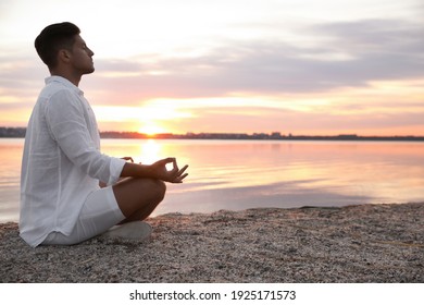 Man near river at sunset, space for text. Nature healing power