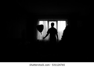 man near the window with a balloon in the hands of. Black and white - Shutterstock ID 531124765