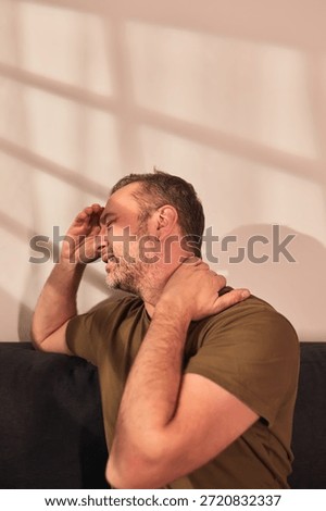 Man with neck, muscle, back and sciatica pain at home.