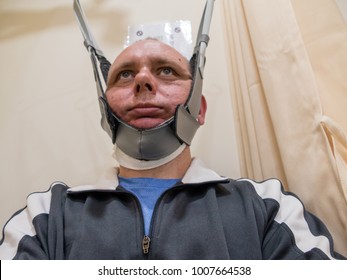 Man In Neck Traction Machine For Physiotherapy