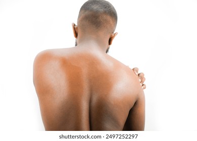 man neck, upper back and trapezius muscles with upper spine, thoracic region marked red. men touches him shoulder, neck, suffer from neck ache, nude man close up ache, upper back shoulder, pain nerve