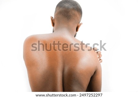 man neck, upper back and trapezius muscles with upper spine, thoracic region marked red. men touches him shoulder, neck, suffer from neck ache, nude man close up ache, upper back shoulder, pain nerve