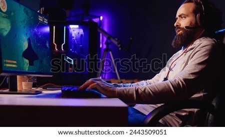 Man in neon lit apartment playing singleplayer videogame with spaceship shooting laser bullets at asteroids. Gamer using crosshair overlay to hit targets in science fiction arcade game, jib down shot