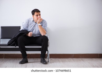 Man nervously impatiently waiting in the lobby - Shutterstock ID 1074698651