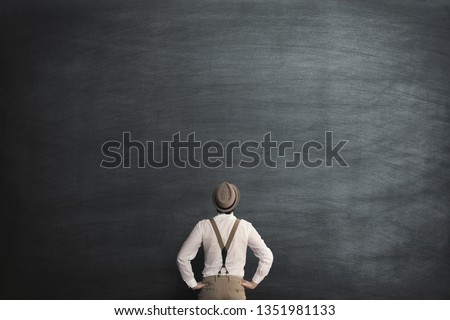 man with no ideas in front of empty blackboard