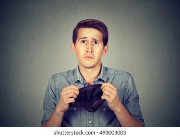 Man with no money. Businessman holding empty wallet