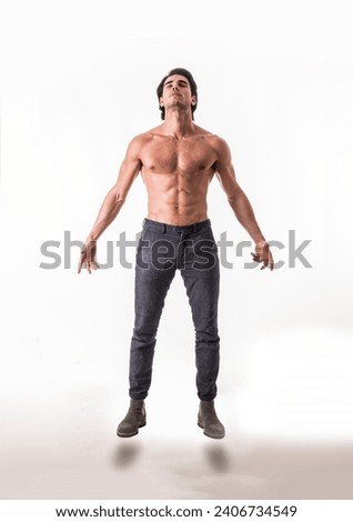 A man with no shirt standing in the air