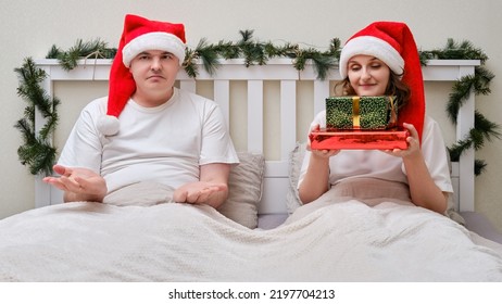 The Man Was Not Given A Gift On The Bed Decorated For Christmas On New Year Eve In The Home Bedroom