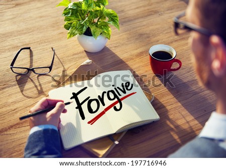 Man with Note Pad and Forgive Concept