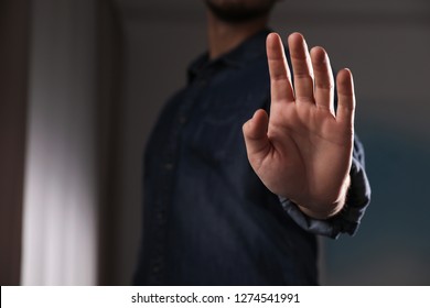 Man offering helping hand on blurred background, closeup. Space for text - Shutterstock ID 1274541991
