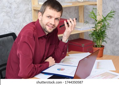 Man In The Office Listens To Voicemail On Mobile Phone