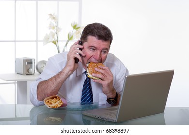 Man At Office With Phone Eat Unhealthy Fast Food