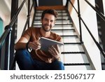 Man, office and portrait with tablet in staircase for creative idea, research and project as interior designer. Business, male employee and smile in startup on for communication and networking