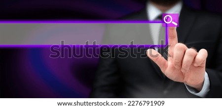 Man in office suit holding tablet and press virtual button with finder. Businessman wearing a black jacket pointing to icon. Futuristic image with important information.