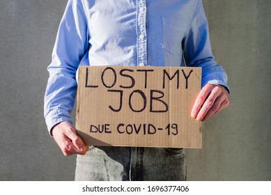 Man Office Worker In Blue Shirt With Cardboard Sign LOST JOB. Jobless, Unemployment Due Covid-19 Concept. Asking For Money