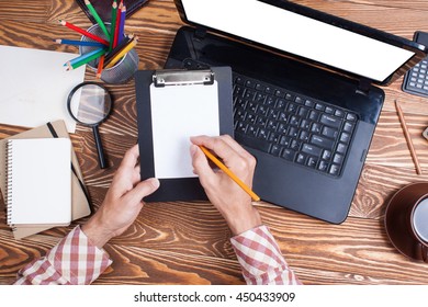 Man in the office working at his laptop. View from above - Shutterstock ID 450433909
