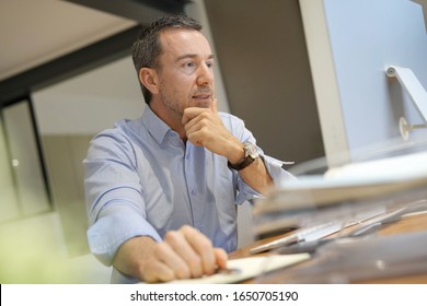 Man In Office Working On Desktop Computer