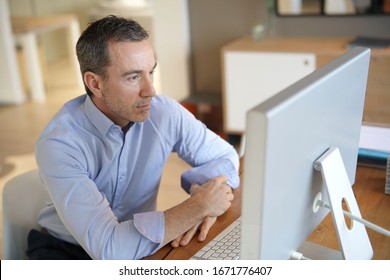 Man In Office Working On Desktop Computer