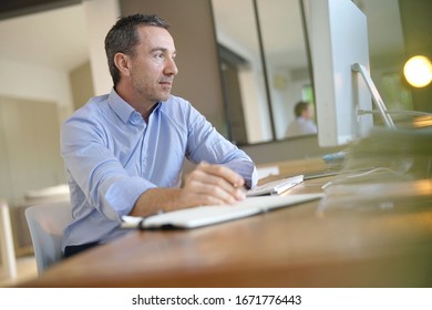 Man In Office Working On Desktop Computer