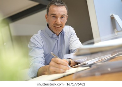 Man In Office Working On Desktop Computer