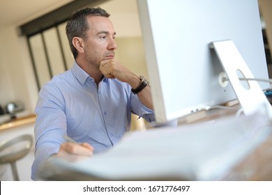 Man In Office Working On Desktop Computer