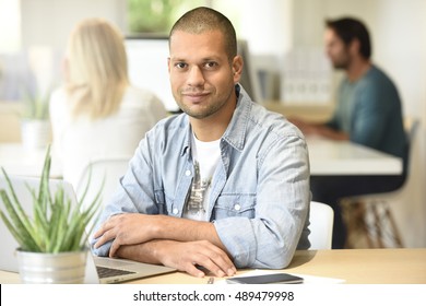 Man In Office Working On Laptop Computer