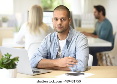 Man In Office Working On Laptop Computer