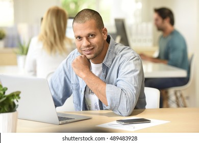 Man In Office Working On Laptop Computer