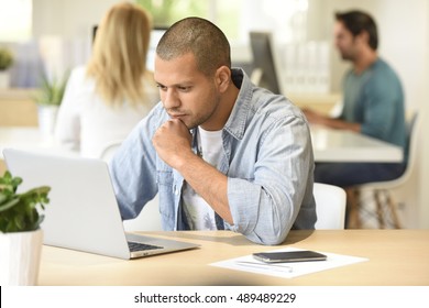 Man In Office Working On Laptop Computer