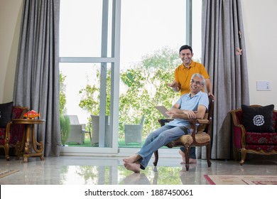 Man With Old Father Using Digital Tablet While Planning Budget Finance