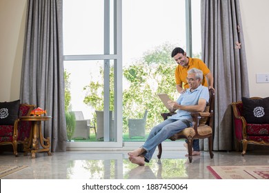 Man with old father using digital Tablet while planning budget finance