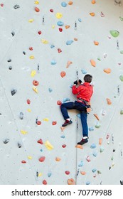 Man On Artificial Exercise Climbing Wall