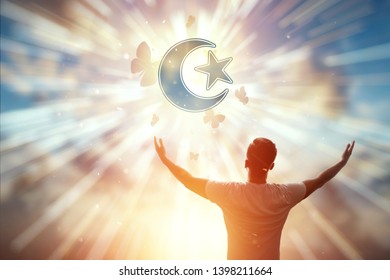 Man on the background of the symbol of Islam, prayer, the star and the month on the background of the sunset. The concept of hope, faith, religion, a symbol of freedom.