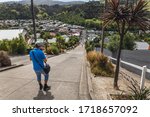 Man on the Baldwin Street world s steepest street in Dunedin, Otago, New Zealand.