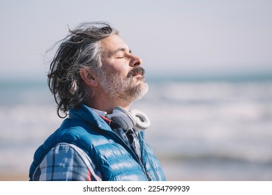 A man on the beach. relaxing deep breathing. - Powered by Shutterstock