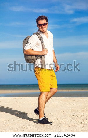 Similar – Junger Reisender am Strand mit Hut und Rucksack