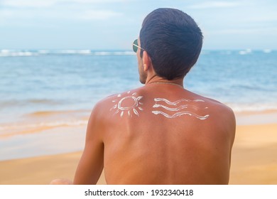 A Man On The Beach With Sunscreen On His Back. Selective Focus. Travel.