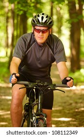 Man on bike riding in the forest - Shutterstock ID 108112349