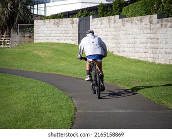 Man On Black Mountain Bike. Stock Photo. Auckland, New Zealand - June 4, 2022