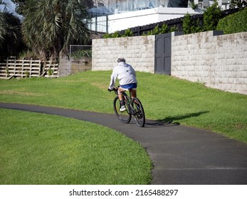 Man On Black Mountain Bike. Stock Photo. Auckland, New Zealand - June 4, 2022