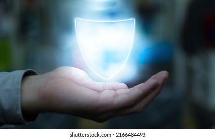 Man on blurred background using digital shield protection blue holographic