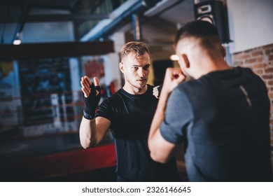 Man on boxing training with instructor on a gym - Powered by Shutterstock