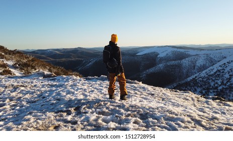 Man on a Cliff Looking at Snowy Mountains - Shutterstock ID 1512728954