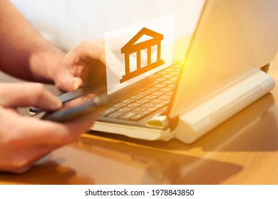 A Man On A Computer Selects A Bank For Investment. Investment Site Selection Concept