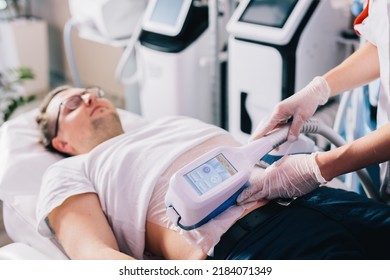 Man on cryolipolysis fat removal treatment on abdomen. Body care at beauty salon - Shutterstock ID 2184071349