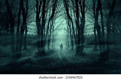 man on dark forest road at night, horror halloween landscape - Shutterstock ID 2196967023